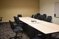Dull empty conference room in an office building with black chairs and neutral tables and colors
