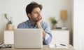 Tired Freelance Guy Sitting Bored At Laptop In Office Royalty Free Stock Photo