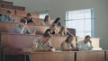 A boring lecture at the university, students look at the screens of smartphones. Many people