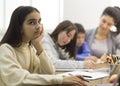 Boring lesson. Upset school girl sitting at lesson