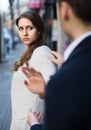 Boring male person accosting to female at crowded street Royalty Free Stock Photo