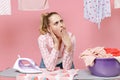 Boring tired woman housewife in checkered shirt dry clothes on rope ironing clean clothes on board doing housework Royalty Free Stock Photo