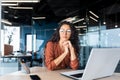 Boring work, hispanic woman working inside office, business woman working at desk using laptop at work Royalty Free Stock Photo