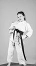 Born to fight. practicing Kung Fu. happy childhood. small girl in martial arts uniform. sport success in single combat