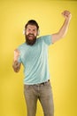 Born to win. Happy winner listen to music. Bearded man make winner gesture. Emotional hipster shout loud yellow