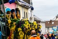 Three women in costumes on a decorated parade float taking part in the carnival parade in Bornheim-Waldorf