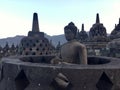 Borobudur Buddhist temple with Merapi mountain at the background .Near Yogyakarta on Java Island, Indonesia