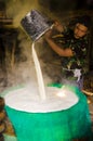 Borobudur, Indonesia - 08/26/2013: A man preparing tofu from the soy beam juice in an improvised conditions Royalty Free Stock Photo