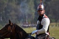 Reenactor rides a horse at Borodino battle historical reenactment in Russia