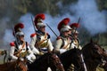 Reenactors cuirassiers ride horses at Borodino battle historical reenactment in Russia