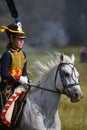 Woman reenactor rides a horse at Borodino battle historical reenactment in Russia