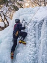 The man climbing up the frozen waterfall