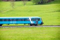 Borovnicka, Czech republic - May 15, 2021. Blue modern train going between green meadows