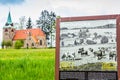 Borovnicka, Czech republic - May 15, 2021. Information board about village with Church Of The Divine Heart Of The Lord in backgrou