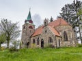 Borovnicka, Czech republic - May 15, 2021. Information board about village with Church Of The Divine Heart Of The Lord in backgrou