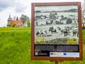 Borovnicka, Czech republic - May 15, 2021. Information board about village with Church Of The Divine Heart Of The Lord in backgrou