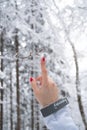 Borowa Gora, Walbrzych, Poland 12-29-2019 - Closeup SUPERDRY jacket brand. Woman`s hand with red nails pointing with index finger