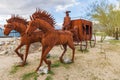 Welded steel sculpture of horses and a stage coach by Ricardo Breceda.