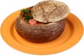 Borsch soup is poured in a dish as bread