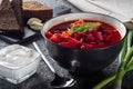 Borsch. Ukrainian soup. The red soup. Borscht with sour cream and onions, rye garlic bread. Royalty Free Stock Photo