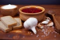 Borscht red soup with rye bread and garlic on a dark background. Borscht with meat and sour cream and dill Royalty Free Stock Photo