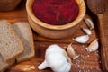 Borscht red soup with rye bread and garlic on a dark background. Borscht with meat and sour cream and dill Royalty Free Stock Photo