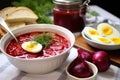 borscht with a side of pickles and hard-boiled eggs