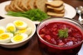 borscht with a side of pickles and hard-boiled eggs