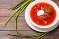 Borscht with sour cream and herbs on a wooden background Royalty Free Stock Photo