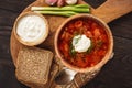 Borscht - traditional russian and ukrainian beetroot soup on wooden background.