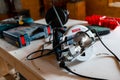 Bosch GKS 190 circular saw , power tools on the table in a small woodworking shop.