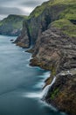 Bosdalafossur waterfall and coastline long exposure, vertical composition in Faroe Islands Royalty Free Stock Photo