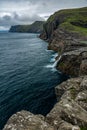 Bosdalafossur waterfall and steep coastline in Faroe Islands