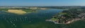 Bosham Village with boats moored in the estuary panoramic view.