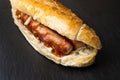 Bosna or Bosner, a spicy Austrian Hot Dog style Fast Food Dish with a Bratworst, Onions, Ketchup and Curry Royalty Free Stock Photo