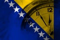 Bosnia and Herzegovina, Bosnian, Herzegovinian flag with clock close to midnight in the background. Happy New Year concept