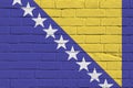 Bosnia and Herzegovina flag depicted in paint colors on old brick wall. Textured banner on big brick wall masonry background Royalty Free Stock Photo