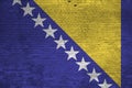 Bosnia and Herzegovina flag depicted in paint colors on old brick wall. Textured banner on big brick wall masonry background Royalty Free Stock Photo
