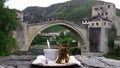 Bosnian coffee with delight and traditional copper serving set  in front of Old bridge in Mostar, Bosnia and Herzegovina Royalty Free Stock Photo