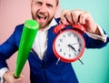 Boss aggressive face hold alarm clock and baseball bat. Man suit hold clock in hand and arguing for being late. Business