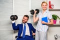 Boss businessman and office manager raise hand with dumbbells. Boost business team. Boost your skill. Man and woman Royalty Free Stock Photo