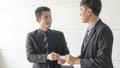 Boss businessman shake hand partner business man and change name card company in meeting conference room