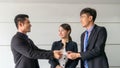 boss businessman shake hand partner business man and change name card company in meeting conference room.