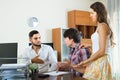 Boss and couple talking with grave countenances in the office Royalty Free Stock Photo