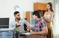 Boss and couple talking with grave countenances in the office Royalty Free Stock Photo