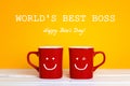 Boss day greeting card with two red coffee mugs with a smiling f