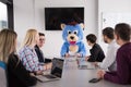 boss dresed as bear having fun with business people in trendy of