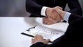 Boss and employee shaking hands, job candidate test lying on table, application Royalty Free Stock Photo