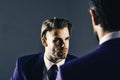 Boss and employee speaking at meeting on dark background. Man in jacket listening his business partner with concentrated