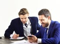 Boss gives instructions to employee. Business partners work with documents and smartphone.